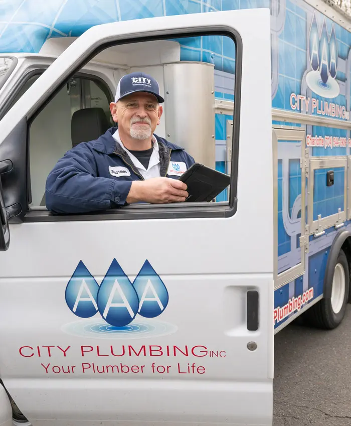 AAA City Plumbing Technician finishing a service call.  AAA City Plumbing expert Tankless Water Heater technician finishing a service call. Reach out today at 704-544-1909.