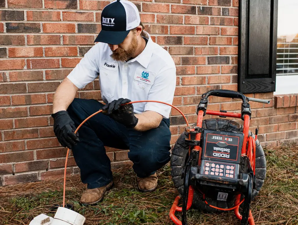 Plumber Frankie Clearing Pipe with Machine